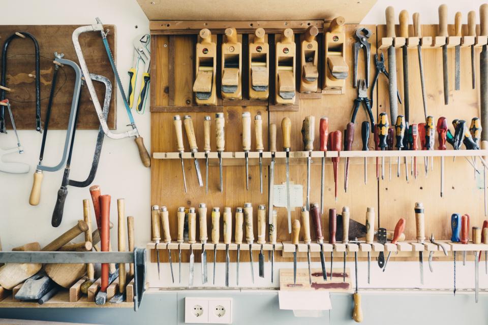 A wall of hand tools organized in a workshop