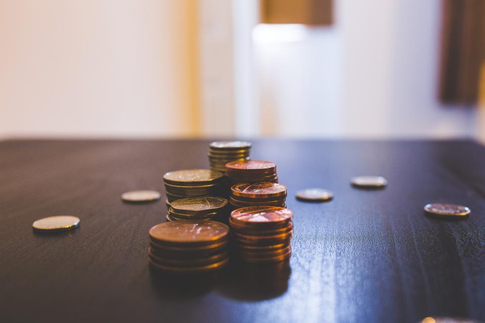 Stacks of coins on a dark wooden table