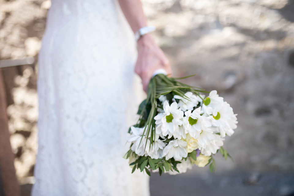 A bride holding a bouquet of white flowers