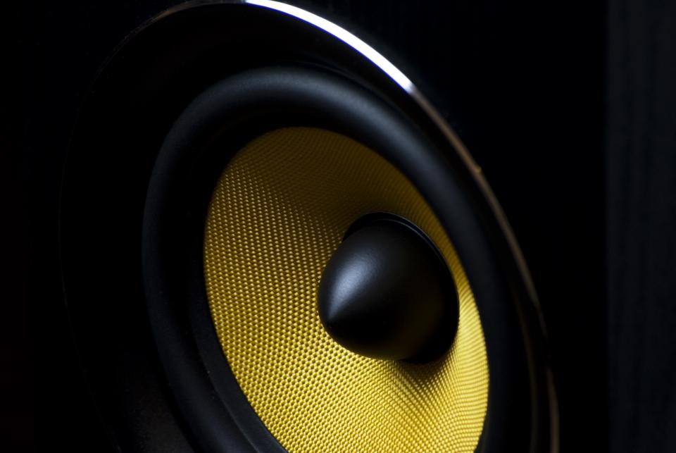 Close up of a black and yellow speaker driver